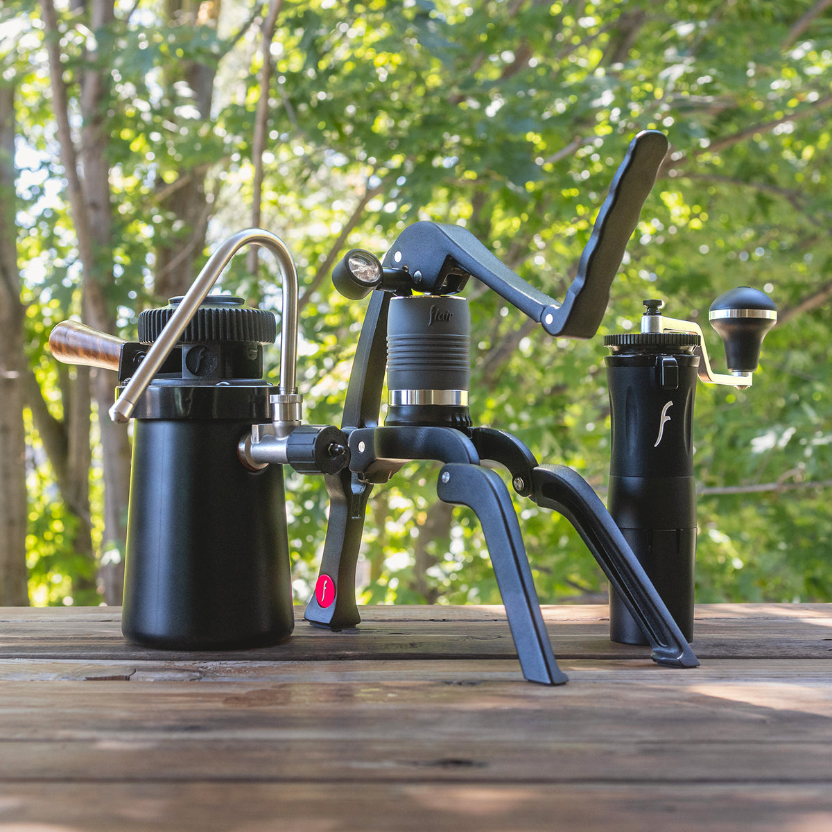 An outdoor photo of the Steam Travel Kit showing the Flair 2GO, Wizard steamer and Royal grinder.