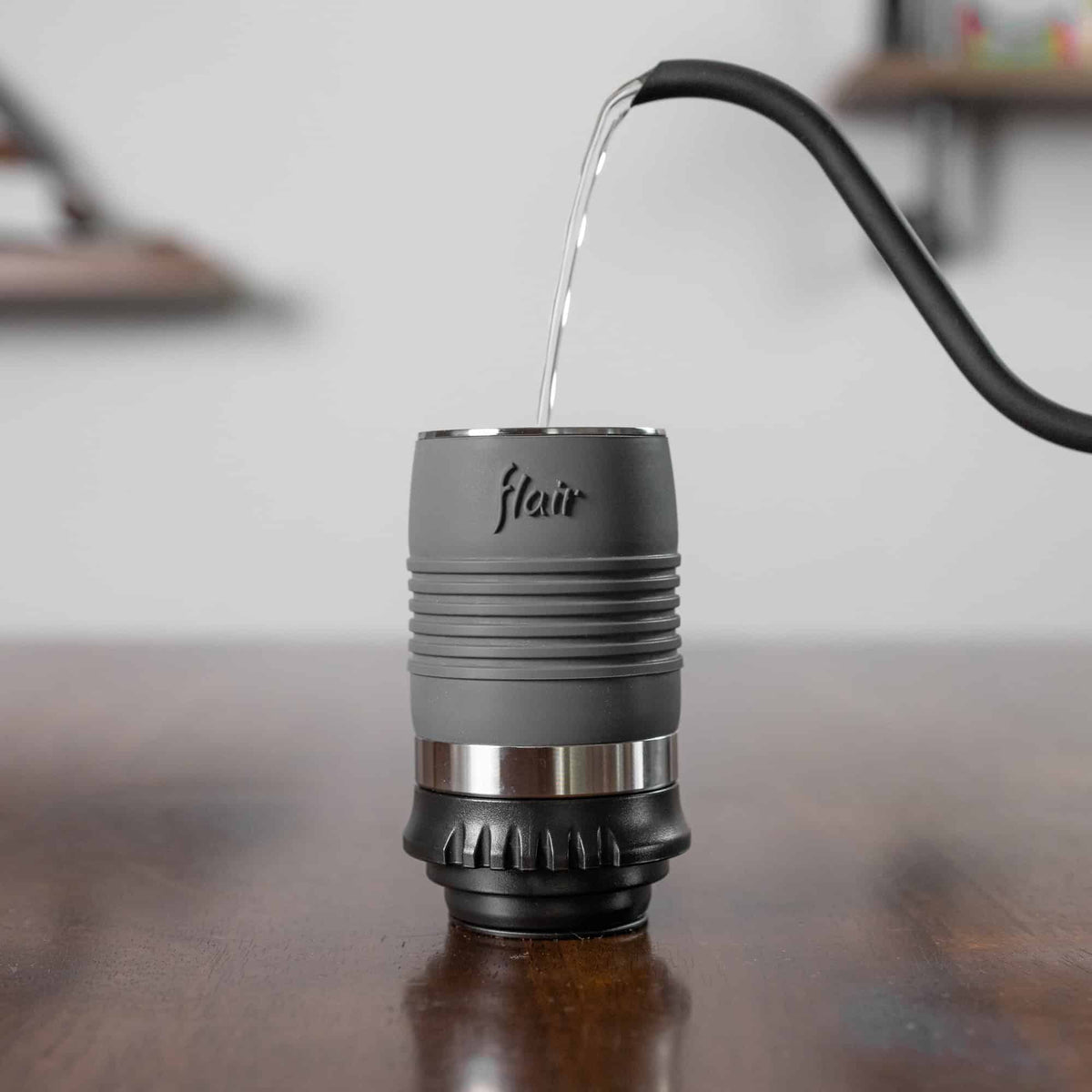 The thin heat efficient cylinder of the Flair Classic with boiling water being poured inside.