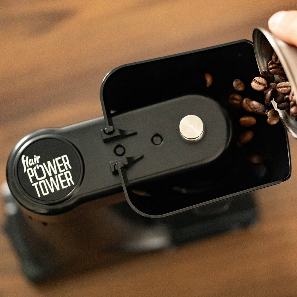 Top down view of the Flair Power Tower with coffee beans being added for grinding.