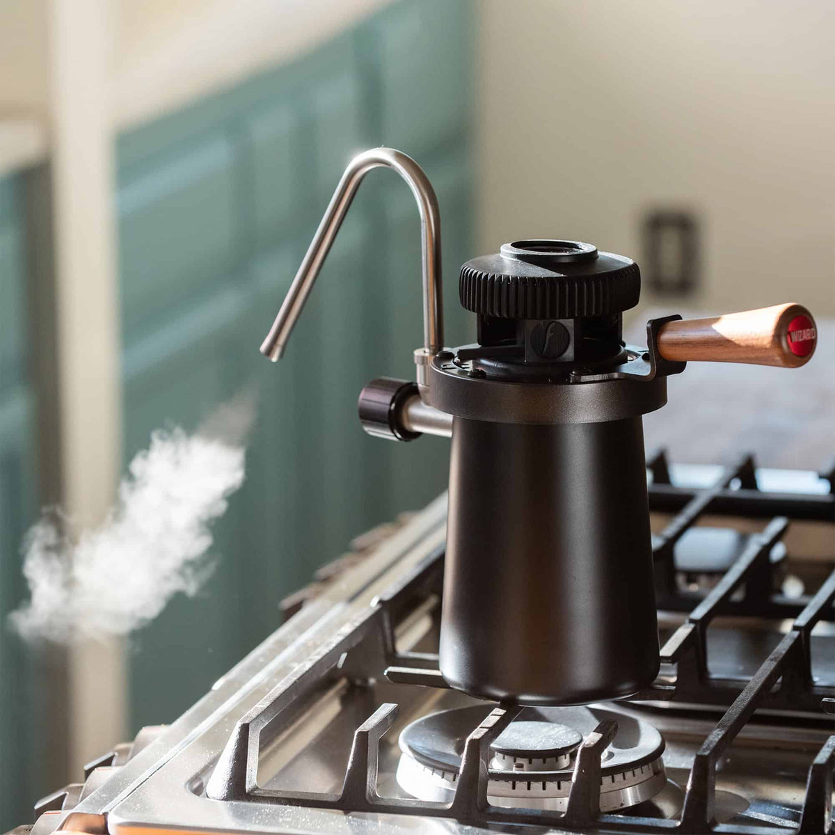 View of the Wizard Stovetop Milk Steaming Wand blowing hot steam for milk.