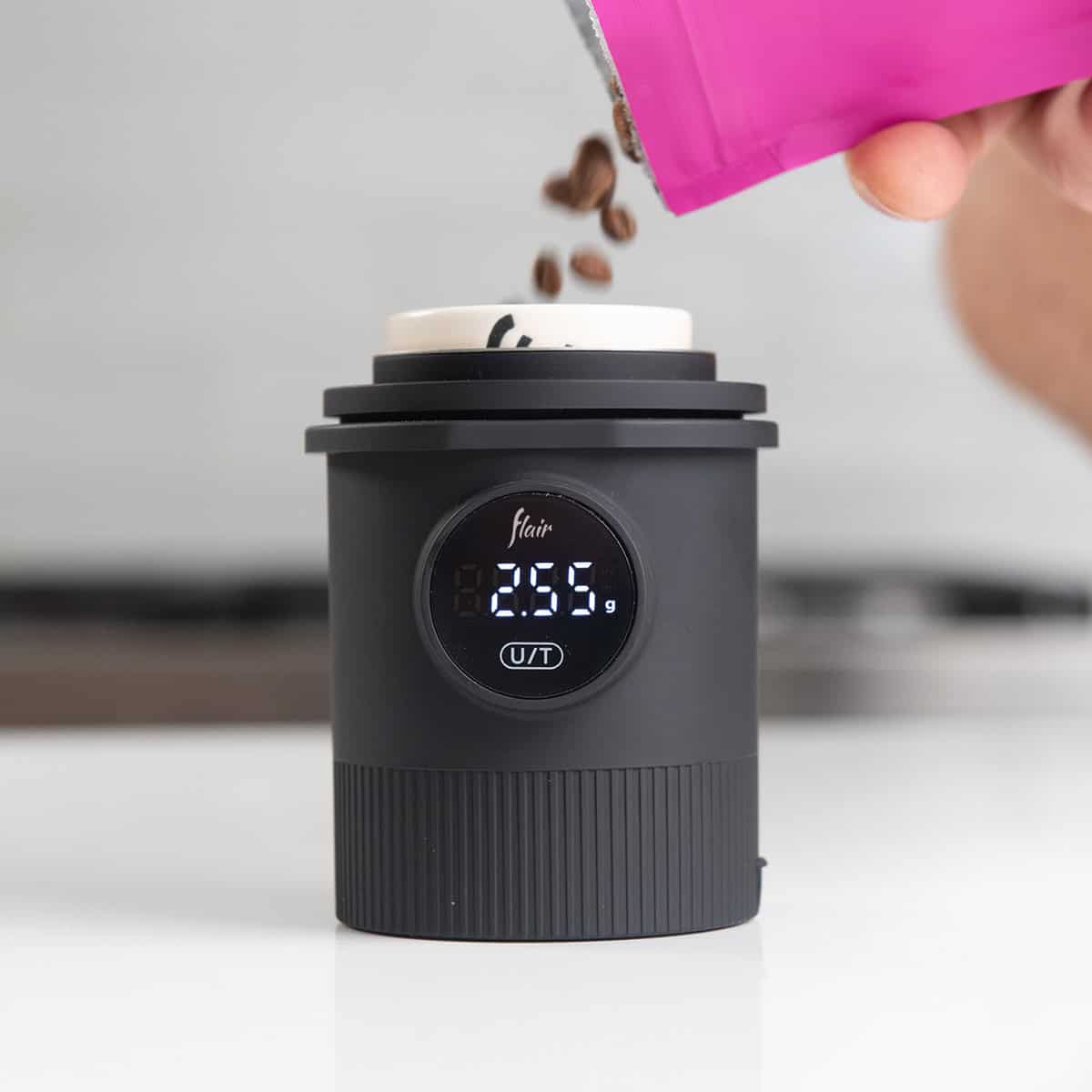 Flair Weigh Cup with beans being added in a nice kitchen