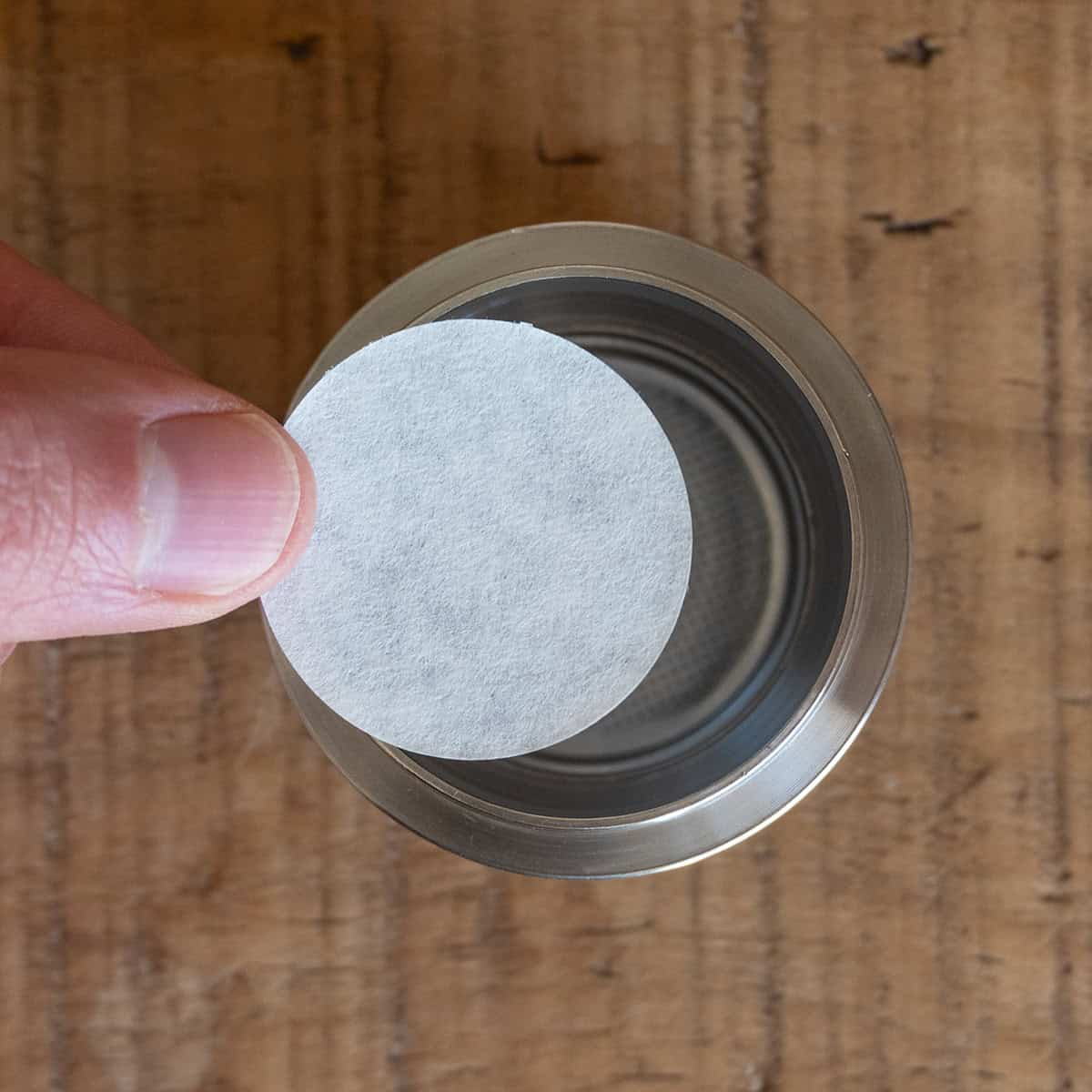 Paper filter being placed inside the basket of the Flair portafilter.