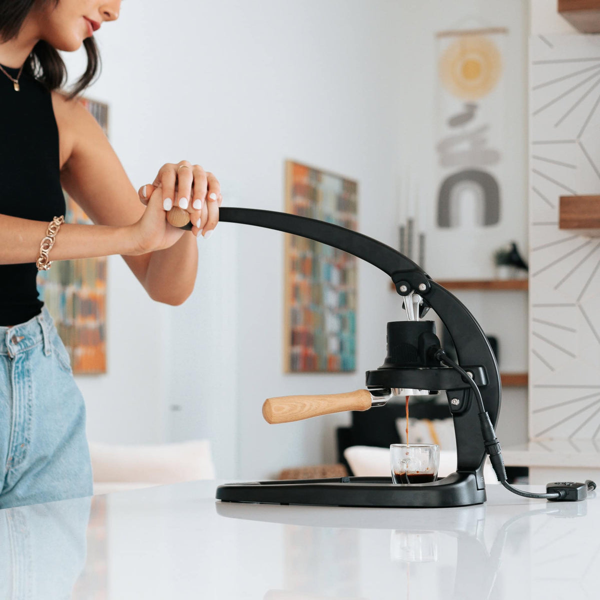 Flair 58 manual espresso maker brewing espresso with a woman