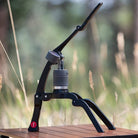 Flair 2GO manual espresso maker on a wooden table outside.