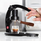 Hand pressing the lever on the Flair 49 PRO manual espresso maker