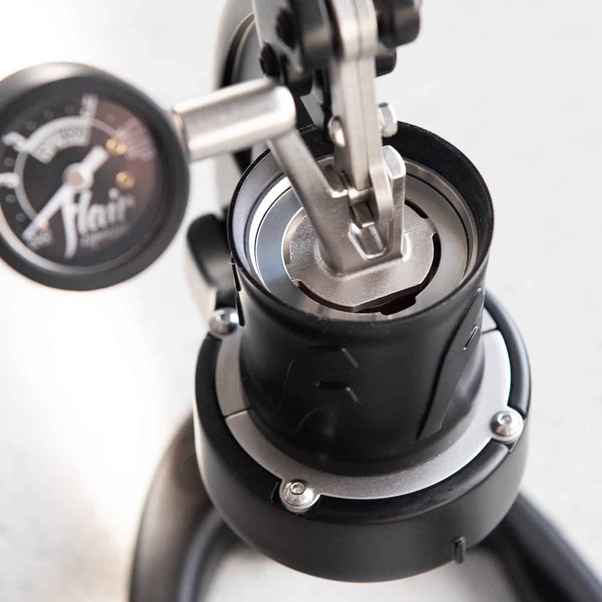The all stainless steel brewing system of the Flair 49 PRO. Showing a stainless steel piston stem and plunger.