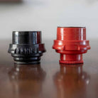 Black bottomless portafilter and red flow control portafilter that come standard with the Flair Classic manual espresso maker.