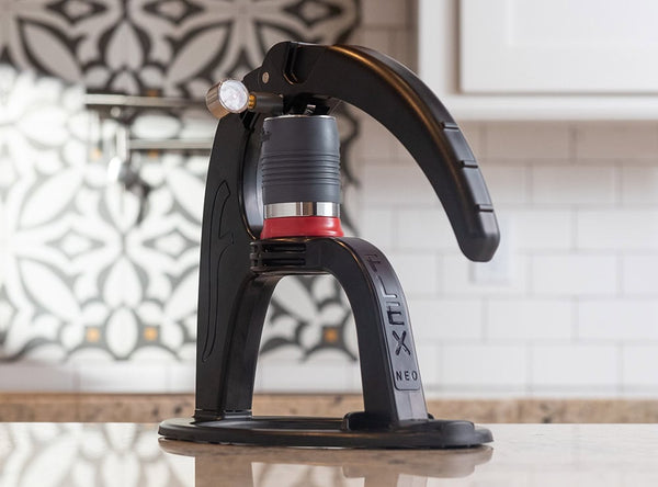 Flair NEO Flex manual espresso maker on a kitchen counter