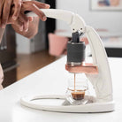 Flair PRO 3 manual espresso maker brewing in a white kitchen.