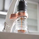 Flair PRO 3 white brewing espresso into a glass cup.